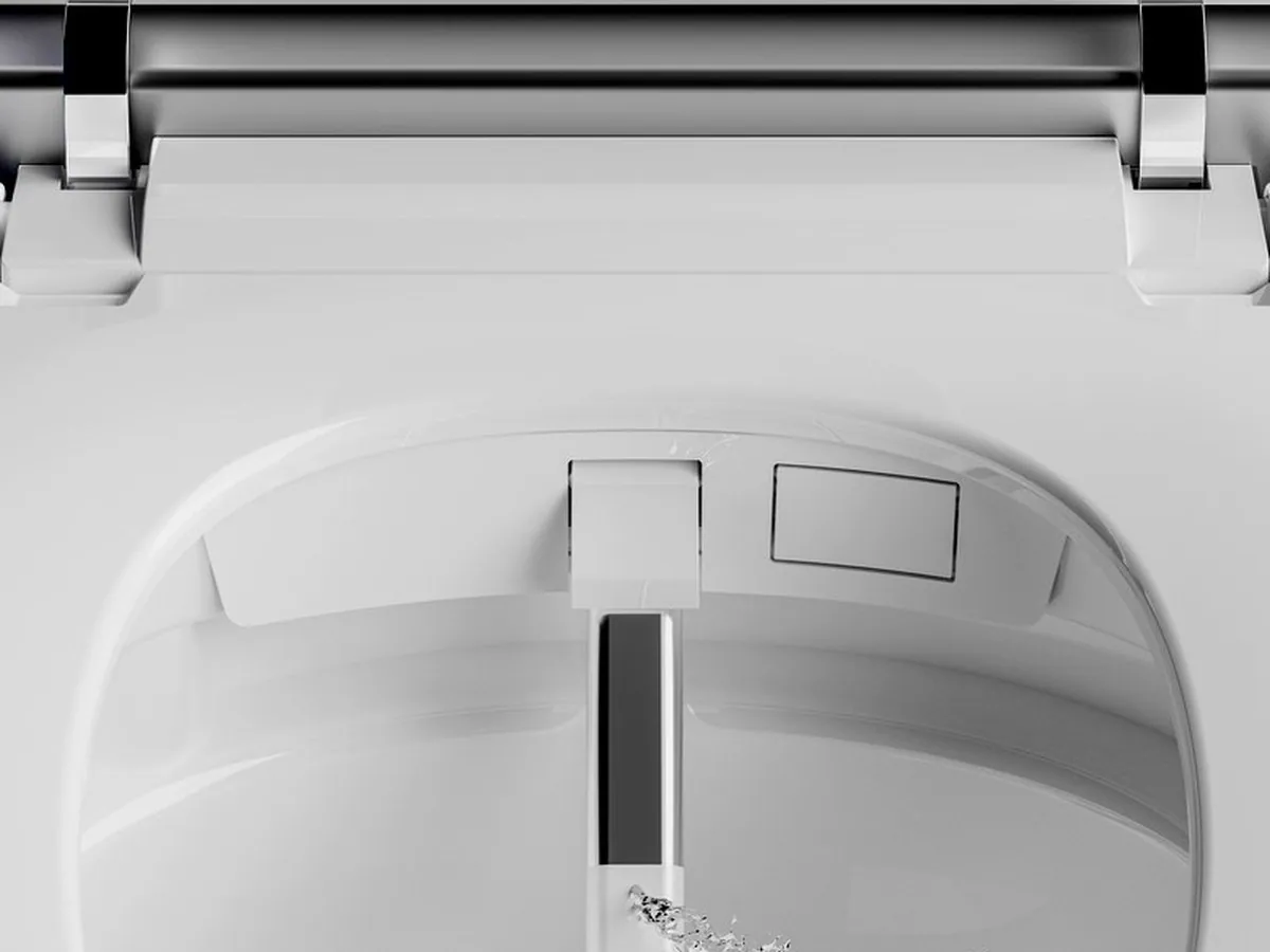 Nozzle extended beneath the seat of a white smart toilet